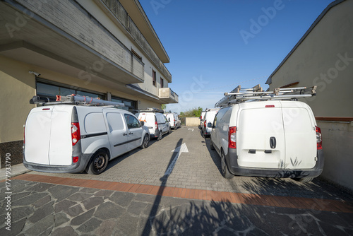 Valokuva Lineup of branded utility vans from electrical firm prepared for technical field