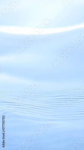 Gentle abstract white lines ripple slowly across light blue gradient surface creating minimal clean motion background symbolizing calm flow and purity in modern design style