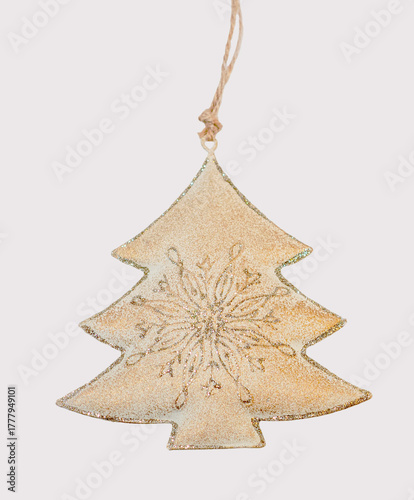 A rustic gold Christmas tree ornament with a glitter snowflake design, isolated on a light grey background.