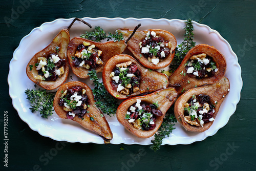 Baked pears. brushed with olive oil and seasoned with some cinnamon. Bake at 375f or 180c degrees for 25 minutes, removed from oven. Add feta cheese, cranberries, walnuts. Garnish with honey and thyme