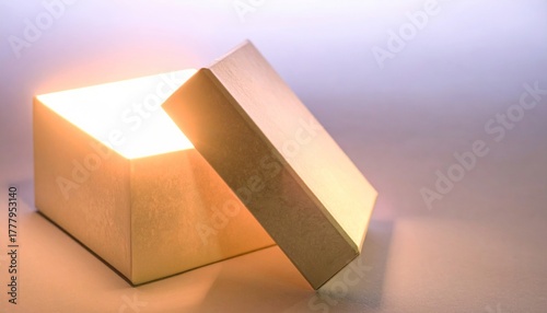 Open glowing gift box with golden light