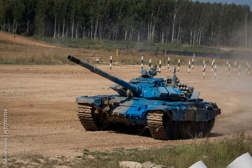 Fototapeta premium Blue Tank in Motion on Training Terrain