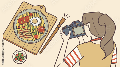 A woman photographing ramen on a wooden board with chopsticks and a side dish in a light setting