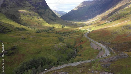 Scenic drone view of a road winding through highlands in Scotland near Glencoe