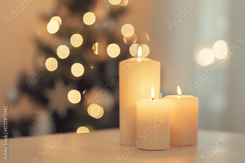 Three candles are lit on a table. Christmas, New Year, Cyber Monday, sale, purchase, black friday