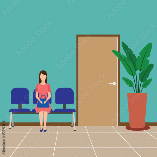 A woman sits patiently on a blue chair in a waiting room, holding a handbag. The room features two chairs, a closed door, and a large potted plant, creating a calm and neutral atmosphere.
