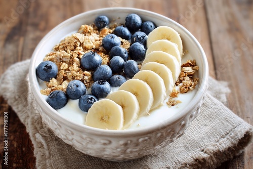 Healthy Breakfast Bowl With Yogurt, Granola, Bananas, and Blueberries for a B...