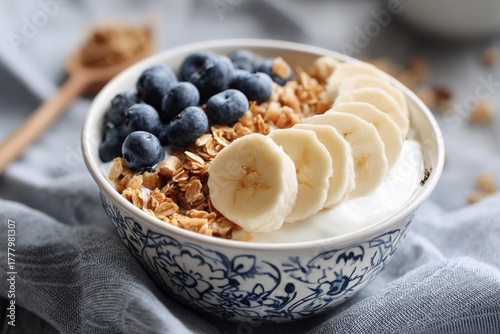 Healthy Breakfast Bowl With Yogurt, Granola, Bananas, and Blueberries for a B...