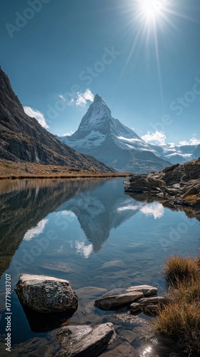 Majestic Mountain Peak Reflects in Tranquil Lake Under Bright Sun in Switzerland
