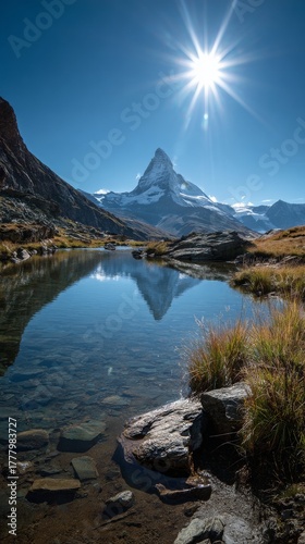 Majestic Matterhorn Peak Reflected in Tranquil Mountain Lake Under Bright Sun...