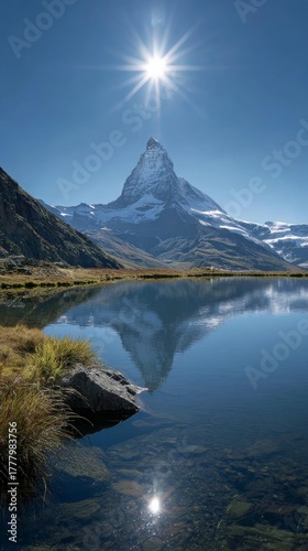 Majestic Matterhorn Peak Reflected in Tranquil Mountain Lake Under Bright Sun...