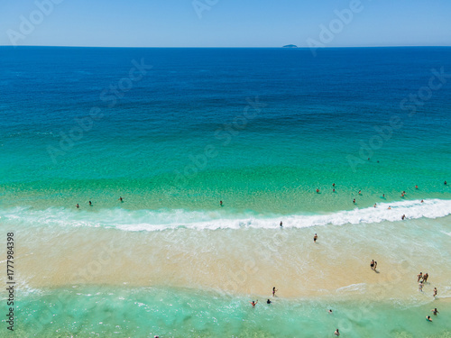 Photography Aerial view of people surfing on crystal clear water in Copacabana Beach, Rio de