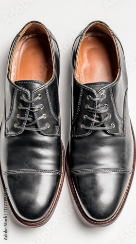 Classic Black Dress Shoes Displayed on a Plain Surface in a Well-Lit Setting
