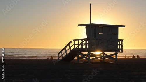 Sun Beyond A Silhouetted Lifeguard Tower
