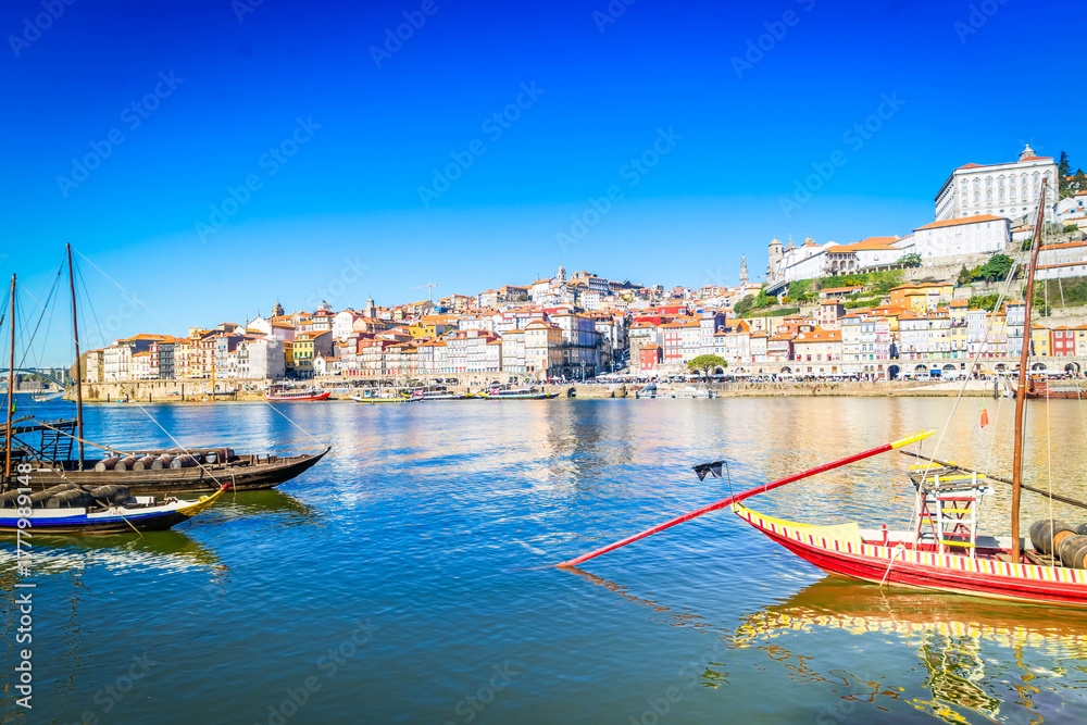 Fototapeta premium Picturesque, colorful view at old town Porto with bridge, Portugal with bridge Ponte Dom Luis over Douro river. Oporto, touristic mediterranean city