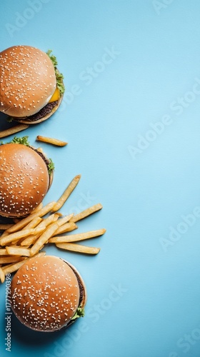 Enjoying Burgers and Fries on a Bright Blue Table