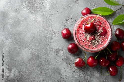 Cherry Smoothie Topped With Fresh Cherries and Chia Seeds on Grey Stone Backg...