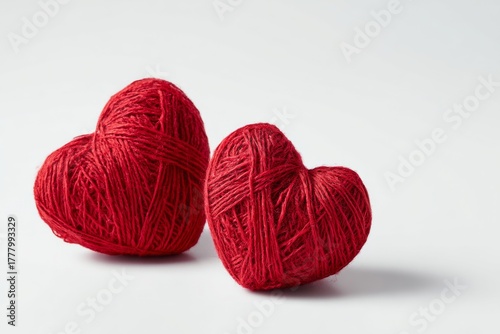Bright Red Yarn Balls Shaped Like Hearts on a White Background for Creative P...