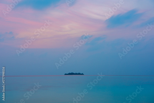 Fototapeta Naklejka Na Ścianę i Meble -  Tranquil closeup calm sea water waves with palm trees. Island at blue hours. Tropical island beach landscape exotic shore coast. Summer vacation, holiday amazing nature. Relax paradise, Maldives.