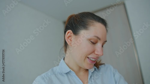 A young, attractive, thirty-year-old brunette woman cradles her infant in her arms. Concept of late motherhood