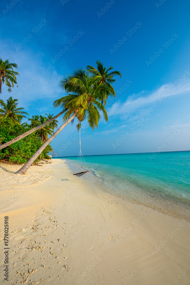 Fototapeta premium Tranquil closeup calm sea water waves with palm trees. Swing on the tree. Tropical island beach landscape exotic shore coast. Summer vacation, holiday amazing nature. Relax paradise, Maldives.