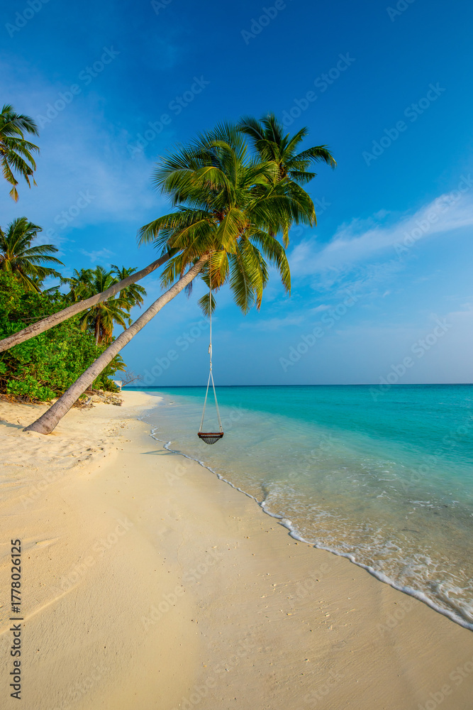 Fototapeta premium Tranquil closeup calm sea water waves with palm trees. Swing on the tree. Tropical island beach landscape exotic shore coast. Summer vacation, holiday amazing nature. Relax paradise, Maldives.