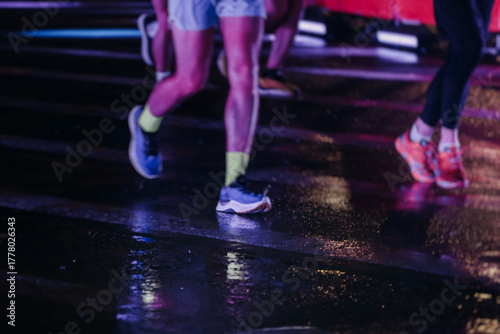 Photography Night marathon runners crowd in the rain, sportsmen participants start running t
