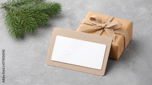 holiday gift for remote worker Gift box with a blank tag and pine branch on a textured surface, perfect for holiday or special occasion gifting.