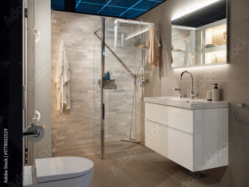 Contemporary bathroom showcasing glass shower storage niches floating vanity and integrated lighting design