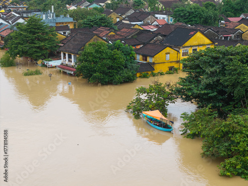 The deepest flood in history in Hoi An, Da Nang 2025. Aerial view of flooded ancient Asian town with yellow houses and brown roofs, showing severe urban flooding and climate disaster impact