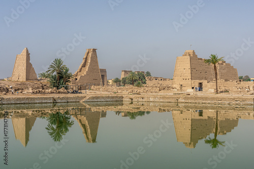 The Sacred Lake at Karnak Temple reflecting ancient ruins and pylons