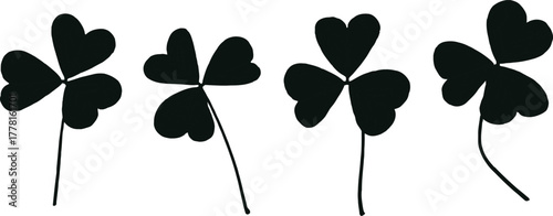 Four stylized black clover leaves with thin stems isolated on a white background