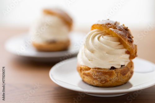 Cream puffs with whipped cream filling on a white plate
