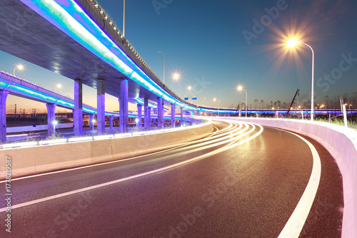 Night view of elevated bridge with blue purple lights