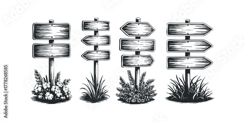 Wooden directional signs with foliage and grass