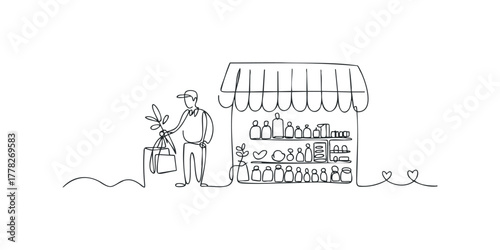 Man with groceries by shop shelves