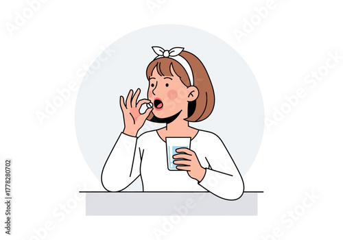 Woman taking a pill with water, perfect for medical and pharmaceutical concepts in marketing materials and presentations.