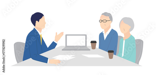 窓口でお客様の接客をするビジネスパーソン