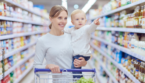 A Busy Mom Shopping with Her Child in a Supermarket