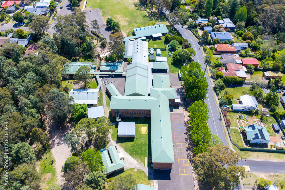 Fototapeta premium Drone aerial photograph of Springwood Public School which is located amongst lush foliage in the lower Blue Mountains town of Springwood in NSW, Australia.