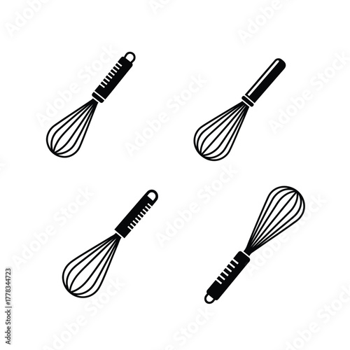 Four black and white wire whisks, kitchen utensils for cooking and baking, isolated on a white background