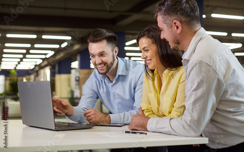Salesman shows samples on laptop to clients in showroom. In a meeting, he gives concise presentation and demo, outlining offer and sale terms. Sales presentation and offer for home renovation.