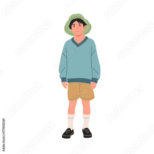 Smiling boy wearing green bucket hat, blue sweater, beige shorts, and black shoes. Cute child character illustration, isolated on white background, flat vector art style.