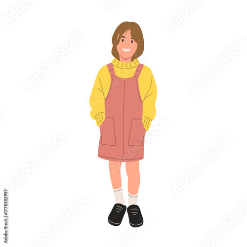 Smiling girl wearing yellow sweater and pink overall dress with pockets. Cute child character illustration, isolated on white background, flat vector art style.