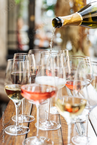 Pouring sparkling wine into multiple glasses