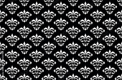 Wallpaper in the style of Baroque. White and black floral ornament. Seamless vector background. Graphic pattern for fabric, wallpaper, packaging. Ornate Damask flower illustration.