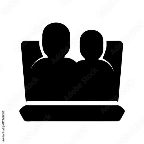 Two audience members sitting in comfortable seats at a theater or cinema
