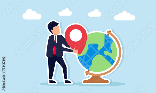 Businessman holding location pin near globe illustration of mapping and projecting potential areas for global business expansion