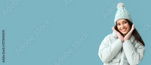 Young woman in warm gloves ...