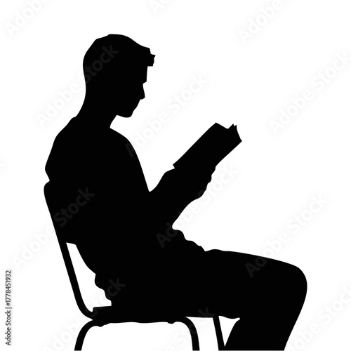 silhouette of a person reading a book